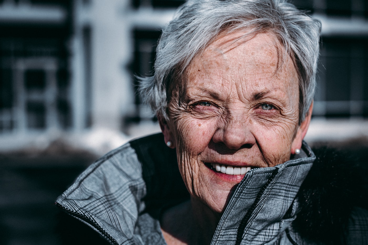 Smiling grey-haired woman outdoors